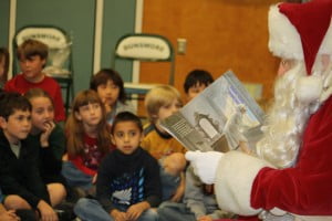 Photos by Mary O’KEEFE Students at Dunsmore Elementary School were treated to a visit by Santa Claus on Friday. Santa read “Twas the Night Before Christmas” written by Clement Clarke Moore. After the reading the students and teachers joined Santa in a round of Christmas carols. 