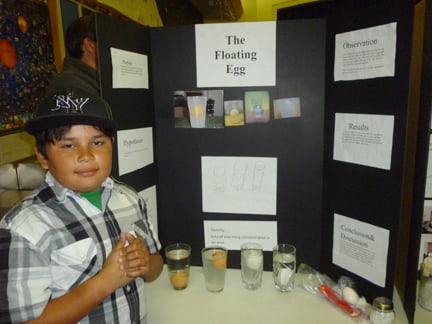 Fourth grade student Jonathan Magna tests for properties of density. Fourth grade student Jonathan Magna tests for properties of density.