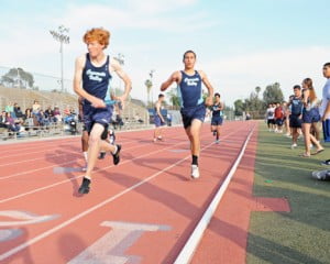 Baton hand off from Alex Damia to Matt Williams in the 1600m relay