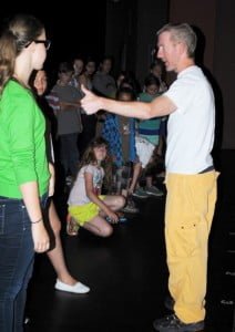 Quinn Kelly (left) talks to choreographer Paul Reid as Eloise Creith (kneeling) looks on. 