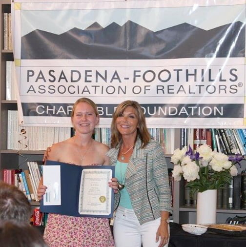 Realtor Lynnell Woodward of Dilbeck Real Estate Real Living, La Crescenta, presents a scholarship to student Rachel Albright.