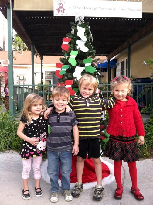 RIGHT: La Cañada Flintridge Community Center Preschool students Teagan and Parker Jahnke, Scott Perkins and Esme Woerner are among those who are experiencing the joy of giving in support of this year’s Adopt-A-Family program benefiting families from Children’s Hospital Los Angeles.