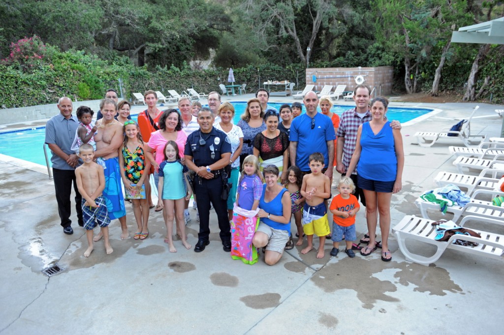 Photo by Leonard COUTIN Attendees of the OWRA National Night Out event gather for a photo near the pool on Tuesday night.