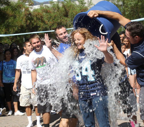 Photo by Mary O’KEEFE CVHS principal Linda Junge meets her Ice Bucket Challenge with help from members of the varsity football team.