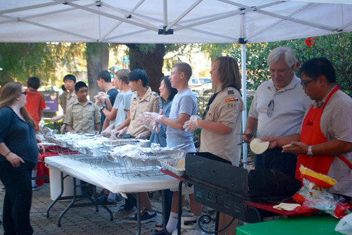 Boy Scouts took turns helping out with the assembly line serving.