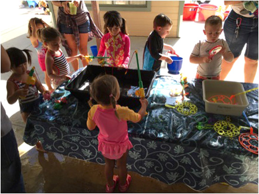 Photo provided by CCNS CCNS Preschoolers playing with bubbles and “fishing” at water play day.