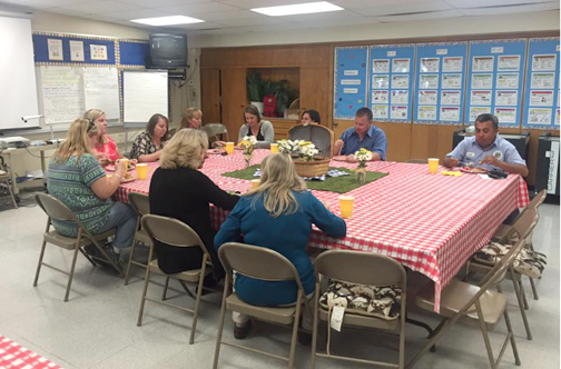 Teachers, staff and Dr. Reynold's enjoying a delicios luncheon by the VV PTA