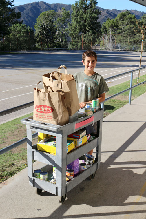 student-council-member-dylan-thomas-is-shown-making-his-rounds-to-collect-food-items-from-the-classrooms