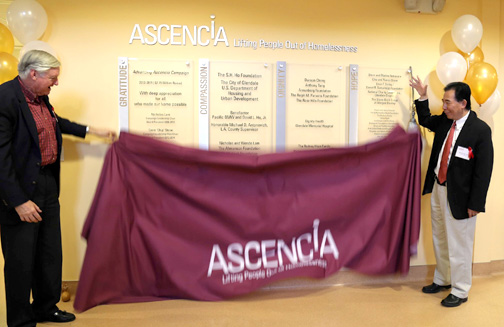 Bruce Hinkley and Nicholas Lam unveil the donor wall at Ascencia.