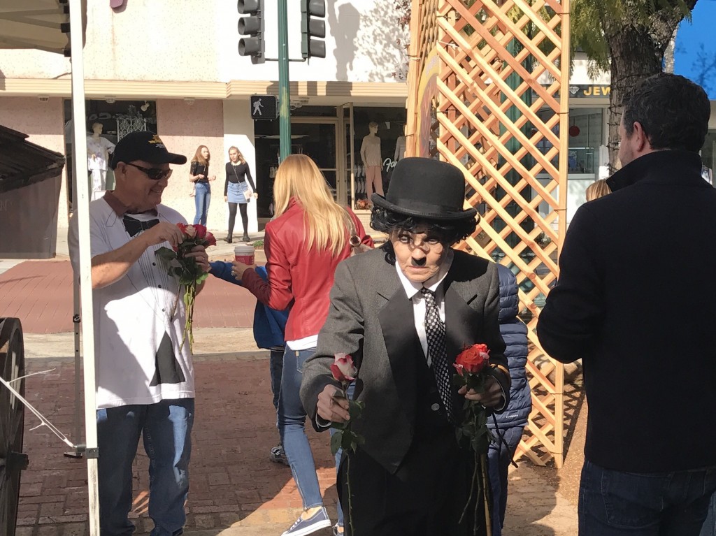Charlie Chaplin impersonator Audrey Ruttan, handed out roses to all the ladies shopping and dining in the popular shopping park.