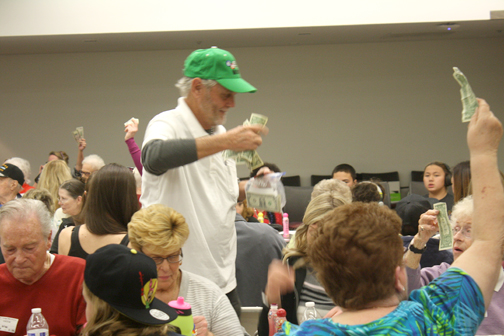 Honorary Mayor Mike Riley collects money for one of three “big chip” games. 