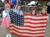 MD-Looking-proud-as-they-hold-up-the-1941-American-flag-that-flew-over-Pearl-Harbor-are-from-left-Sophia-Bergman-7-Lilian-Burnett-8-Brianna-Bergman-5-and-Lani-Kingston-6