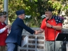 MIKE-BALDWIN-LEFT-LOOKS-ON-AS-Lt.-Col.-Andrew-Burghdorf-USAF-RECEIVES-A-CHALLENGE-COIN-FROM-ROBERT-WOLLENWEBER