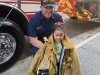 NNO-At-NNO-activities-at-Bolton-Hall-Firefighter-Evan-McDevitt-lets-Sophia-try-on-his-turnout-jacket