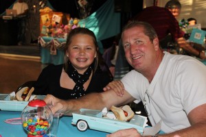 Camryn Christensen and her dad Scott enjoy their hot dogs in their ‘50s car.