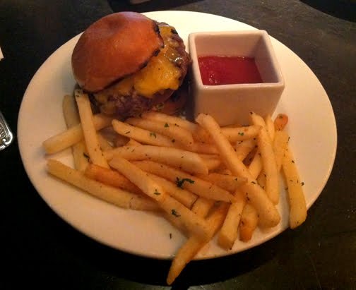 Happy Hour at The Fat Dog features specially priced gastro pub fare like this seared Vermont Cheddar burger with fries.