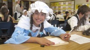 Rachel Diaz practices her calligraphy writing on the horn book.