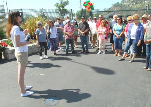 A Rose Bowl tour guide leads the first group of guests on a tour of the stadium on Saturday.