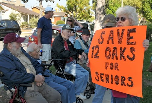 Photo by Dan HOLM Four veterans (seated above at a recent protest) who thought they would spend the rest of their lives together at Twelve Oaks are looking at relocating now that the property is for sale. Band of Brothers … Broken Up
