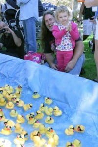 Makenna Eatherton, 2, of La Crescenta watches the ducks race down Lake Glendale with her dad Jay. 