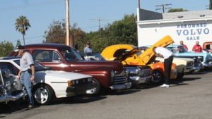 ABOVE: Members of the Early Rodders Car Club lined up their classic cars at the Bob Smith Toyota lot for enthusiasts. ABOVE RIGHT: Dwight Sityar, left, of the Early Rodders Car Club presents Mike Smith with certificates of congratulations for serving the community for 20 years.