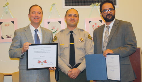 Photo by Mary O’KEEFE Rep. Adam Schiff, left, and Rafi Nazarians, right, of Sen. Barbara Boxer’s office, recognized LASD Deputy Tai Plunkett for bravery demonstrated during a stabbing.