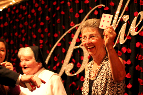 Joan Harper pulls the winning card for the jewelry raffle.