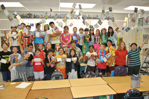 Kristie Colegate’s class is shown displaying some of their postcards.
