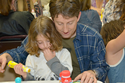 Mike Shaar of S.I.G. Property Management looks over his cards with his daughter.