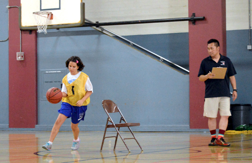 Photos by Brandon HENSLEY Rosemont girls’ basketball coach Bon Sam looks over the ball handling by a prospective player during tryouts.