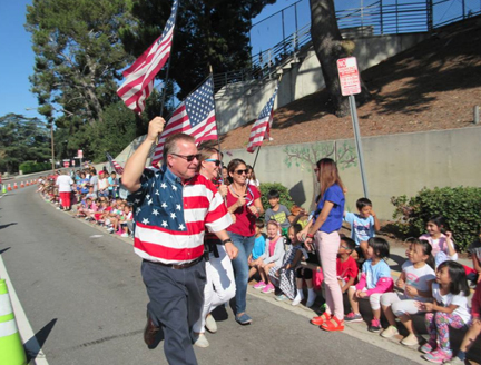dr-reynolds-with-teachers-wave-the-flag-as-students-cheer-at-valley-view-web