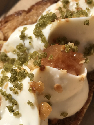 Chèvre fromage blanc tartine infused with rosemary and honey, topped with toasted hazelnuts