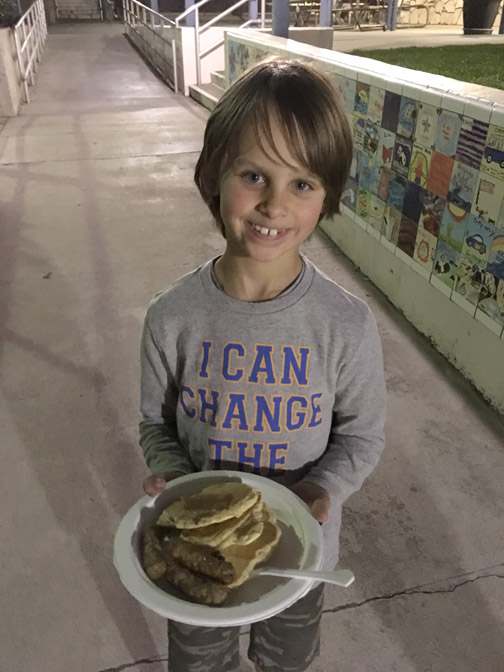 First grader, Aiden enjoying his pancake dinner before reading night