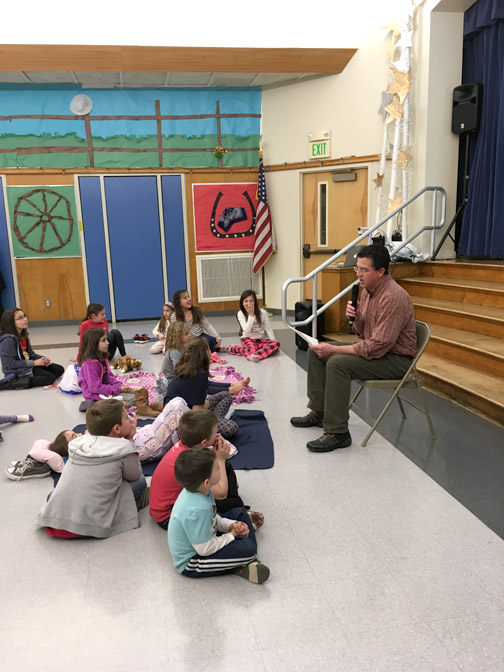 PTA parent, Chris Barnes, begins the night's reading